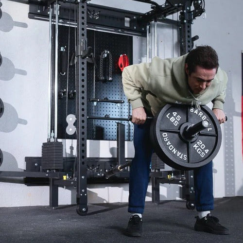 Person lifting a barbell with weight plates in a gym setting