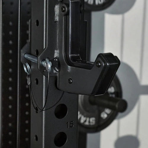 Close-up of a black weightlifting barbell with weight plates on a light gray background