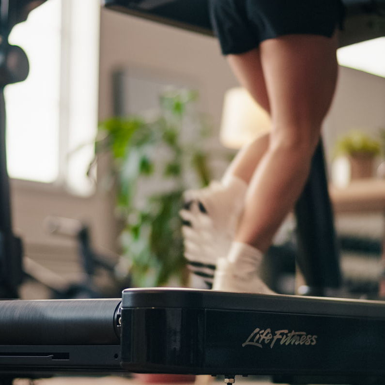 Person using a Life Fitness treadmill in a home setting