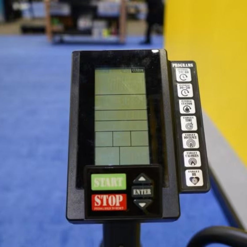 Close-up of a digital display on a piece of exercise equipment with a blurred background.