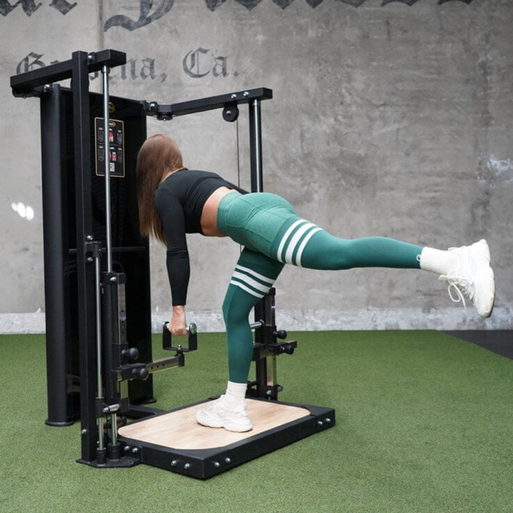 Person exercising on a piece of exercise equipment in a gym setting with &