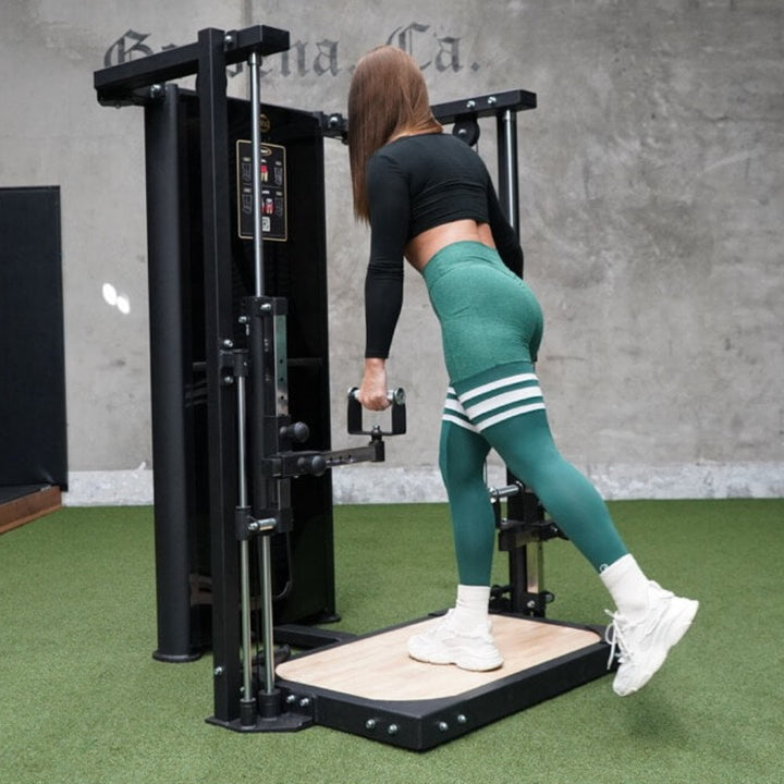 Person exercising on a piece of fitness equipment in a gym with &