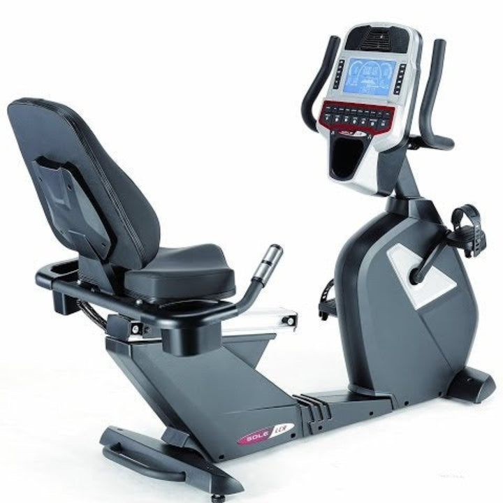 A recumbent exercise bike with a black padded seat and backrest, dark gray frame, and a digital console display mounted on the handlebars, shown on a white background.