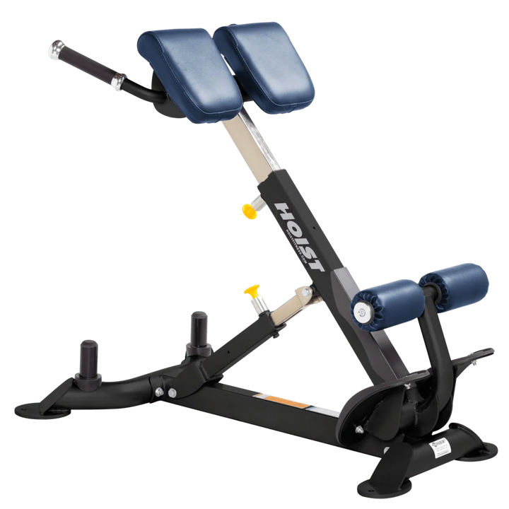 A HOIST brand abdominal exercise machine with blue padded backrest and roller elements, a black metal frame, and silver adjustment components, isolated on a white background.