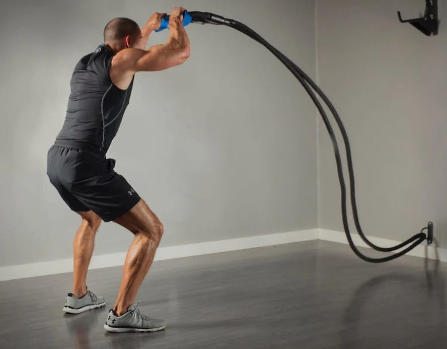 Man exercising with resistance bands in a home gym setting