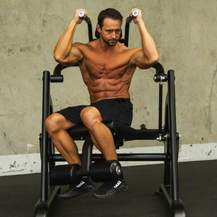 Man exercising on a weight machine in a gym setting