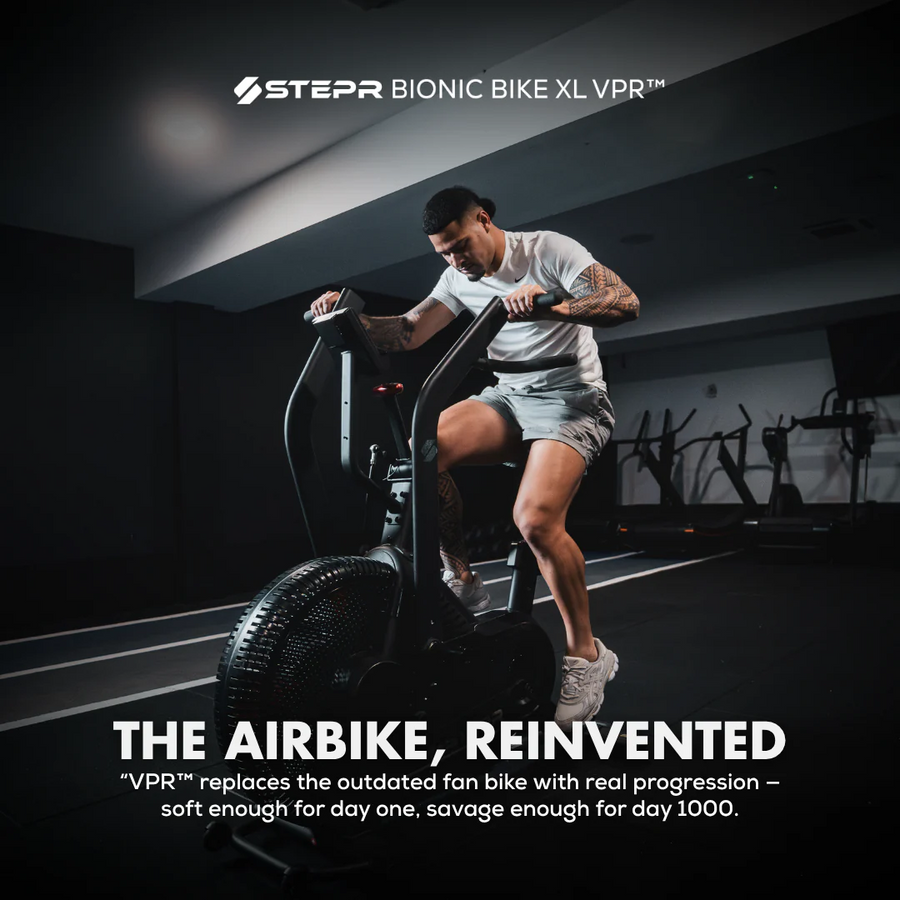 Person using a Stepr Bionic Bike XL VPR in a dark indoor setting
