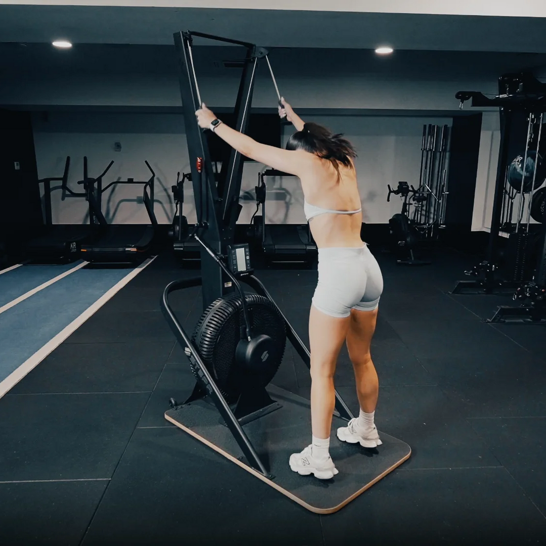 Person using an exercise machine in a gym setting