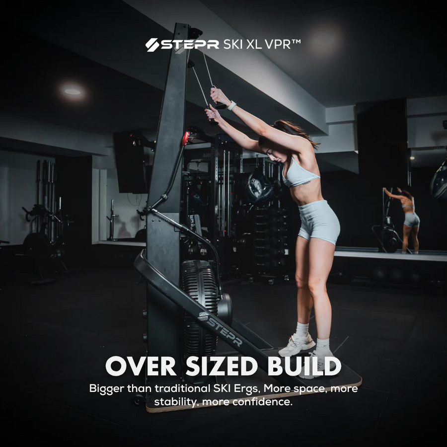 Person using a large exercise machine in a gym with 'Stepr' branding.