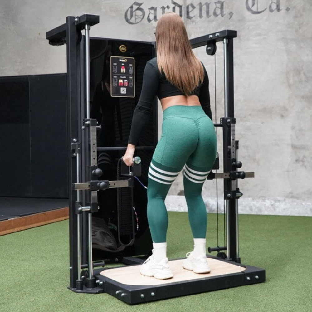 Person using a cable machine in a gym setting with &