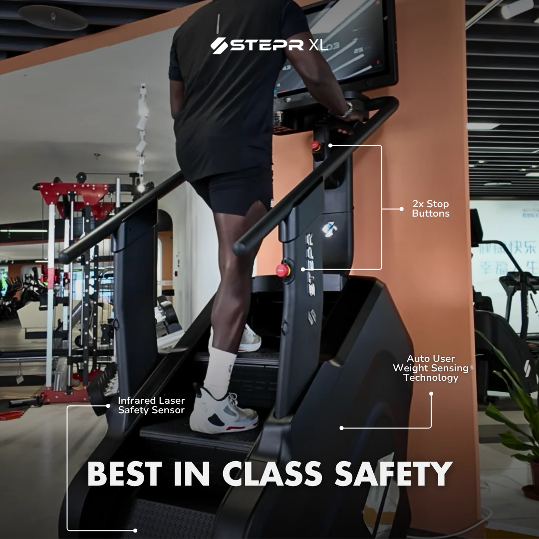 Person using a Stepr XL treadmill with safety features highlighted in a gym setting.