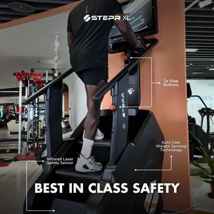 Person using a Stepr XL treadmill with safety features highlighted in a gym setting.