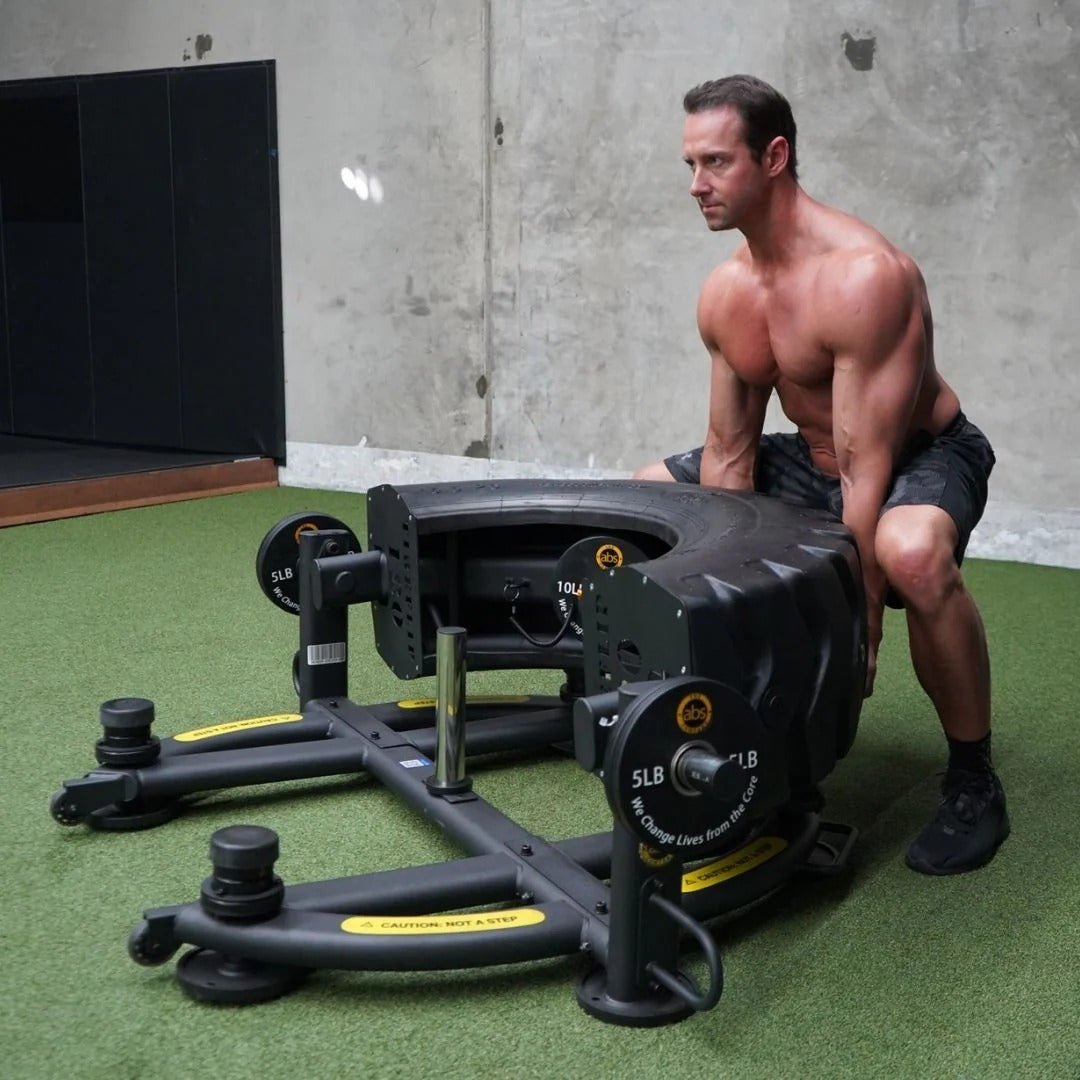 Man exercising with a large piece of fitness equipment in an indoor setting.