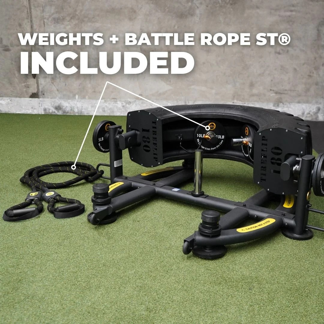 Fitness equipment with weights and battle rope on a green surface
