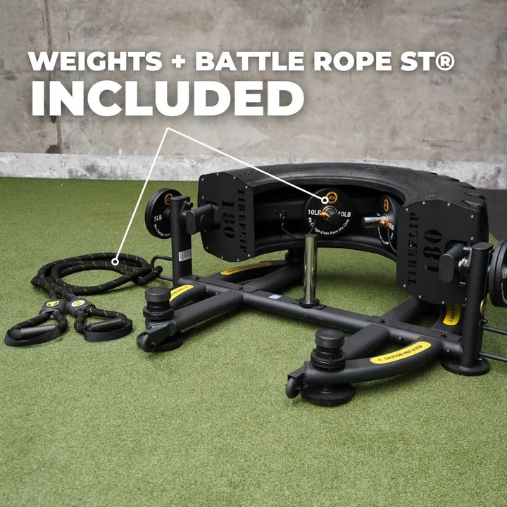 Fitness equipment with weights and battle rope on a green surface