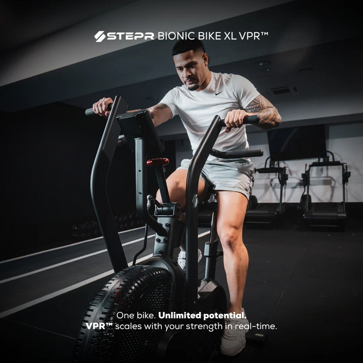 Man exercising on a Stepr Bionic Bike XL VPR in a gym setting.