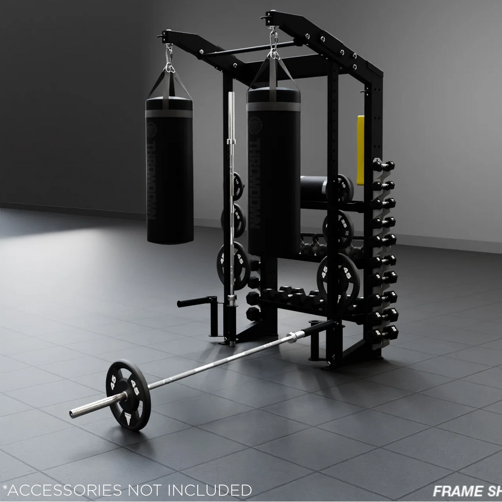 Gym equipment frame with weights and punching bags on a dark floor and wall.