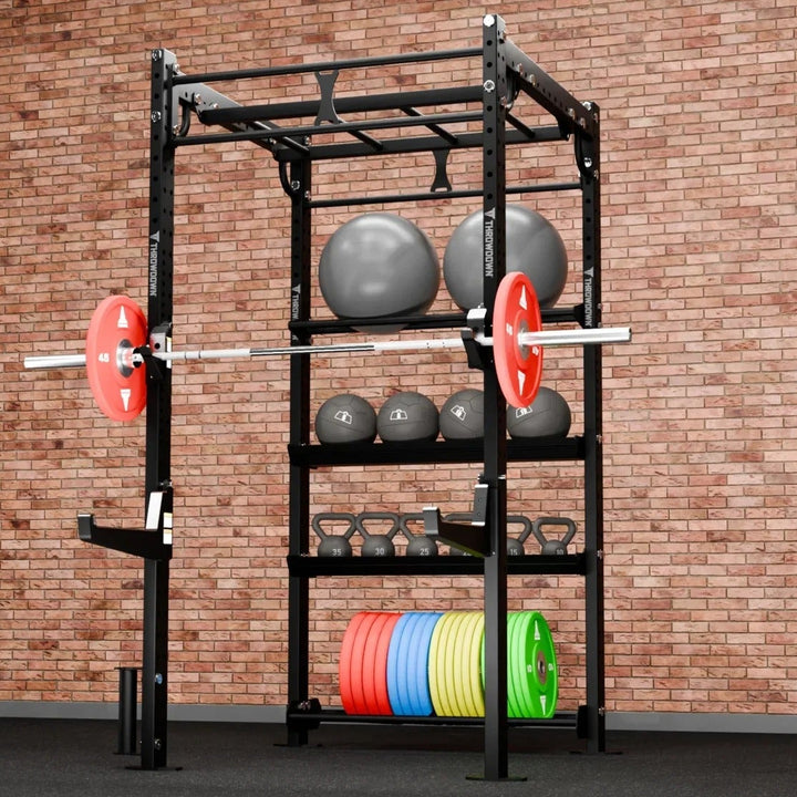 Gym rack with weights and barbell against a brick wall