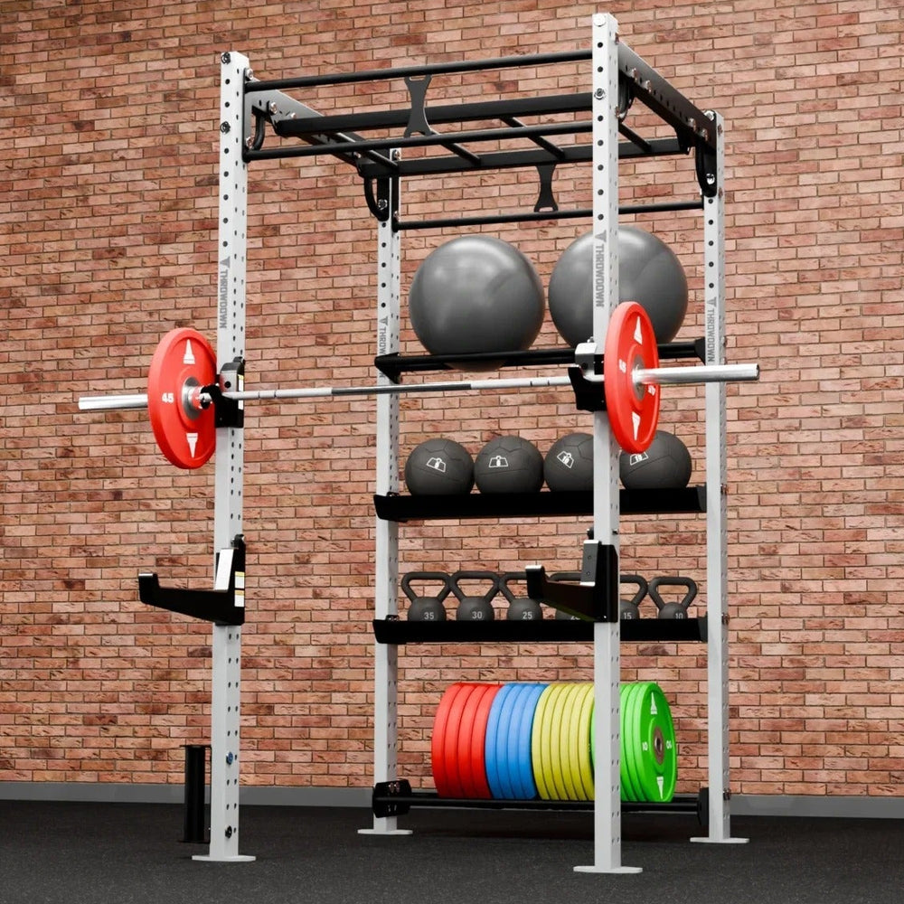 Gym weight rack with weights against a brick wall