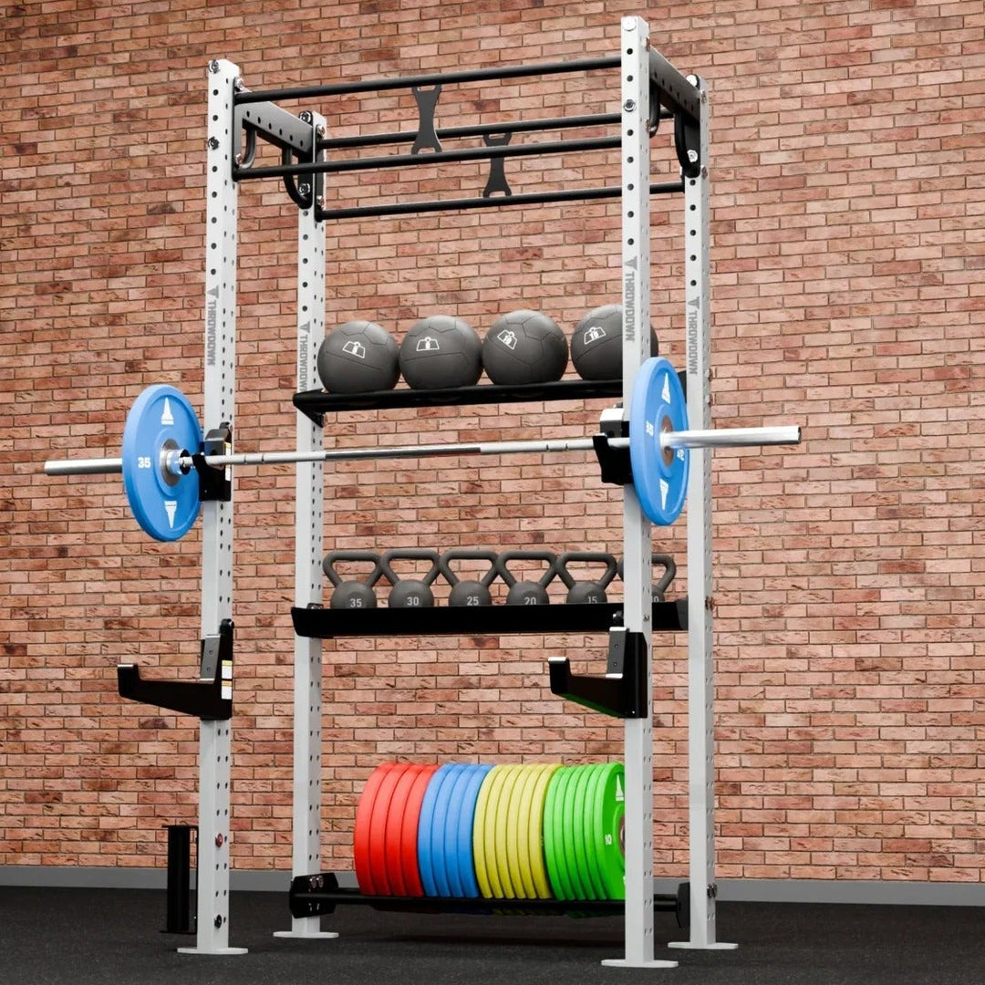 Gym rack with weights against a brick wall
