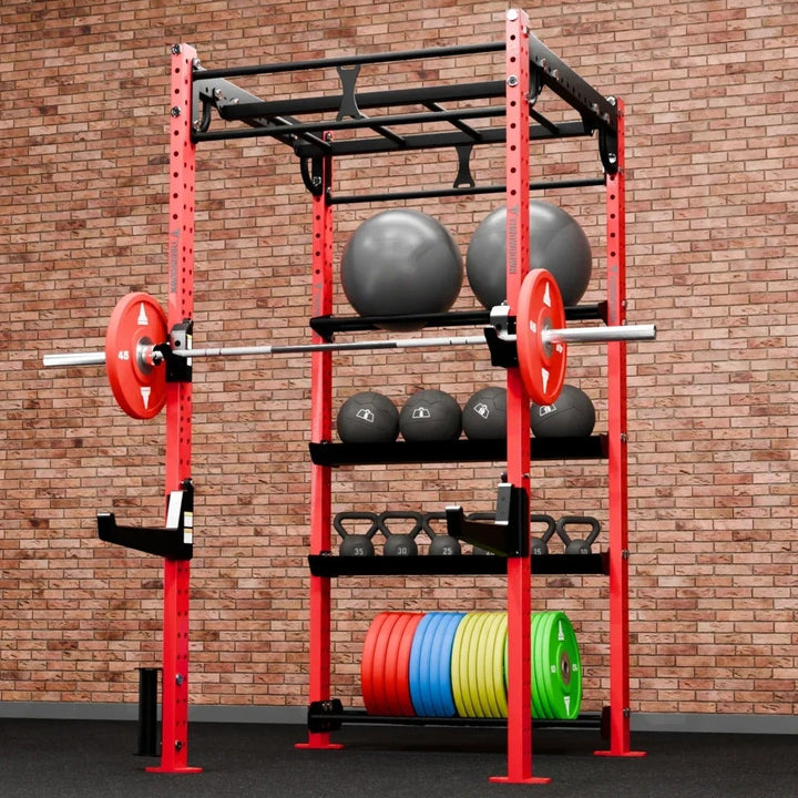 Red weightlifting rack with weights against a brick wall