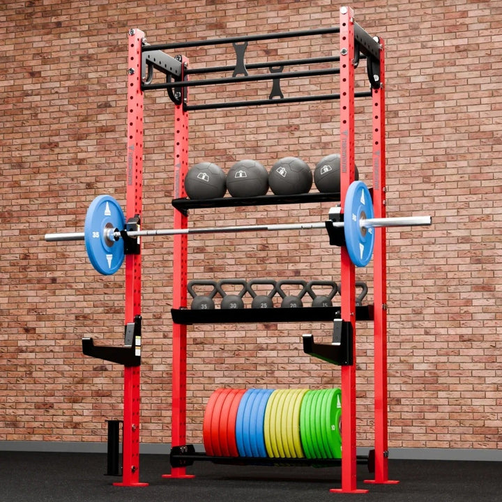 Gym rack with weights and barbell against a brick wall