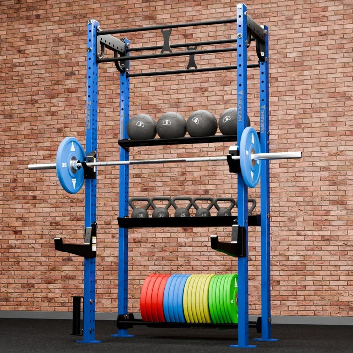 Weight rack with weights against a brick wall