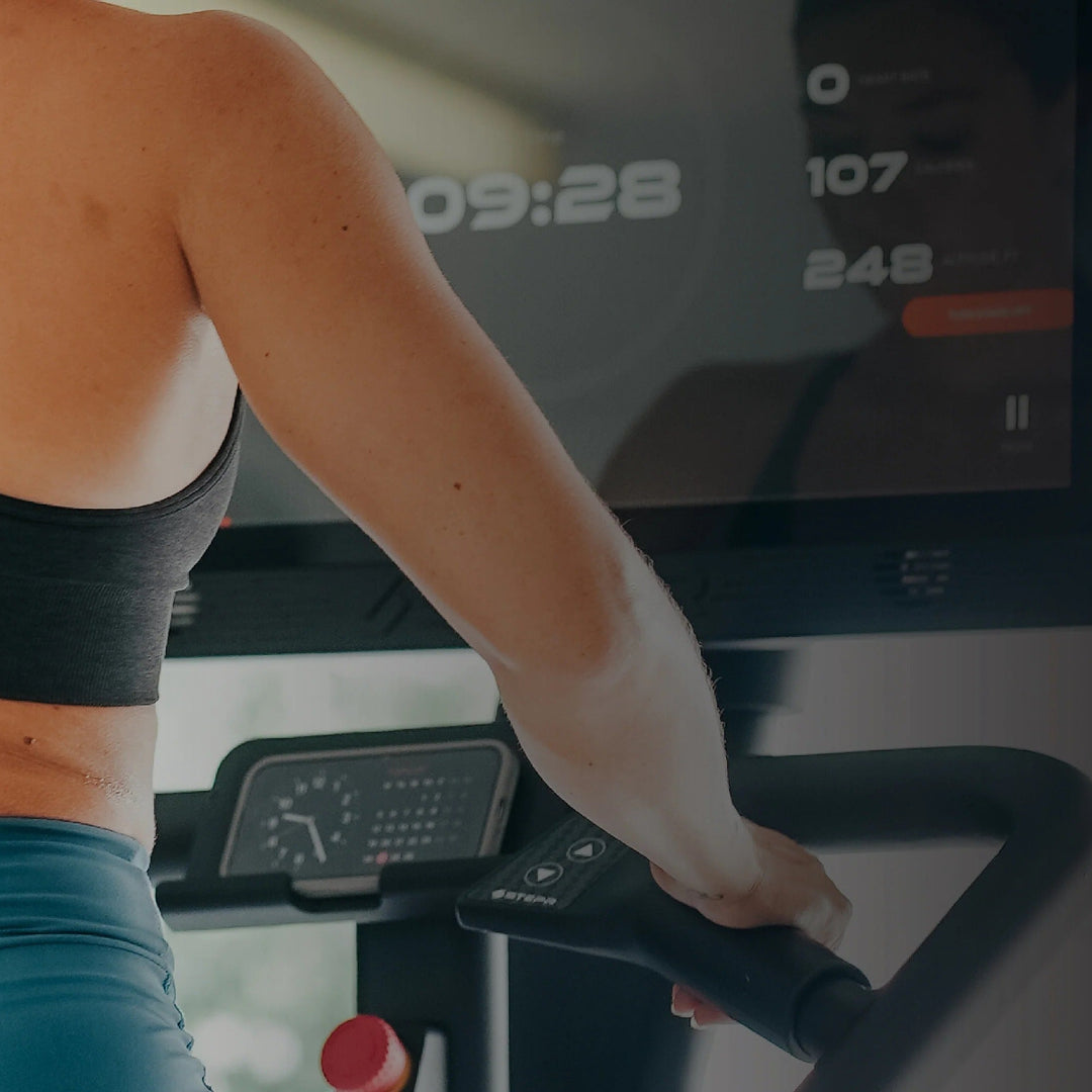 Person exercising on a stair climber in a gym setting