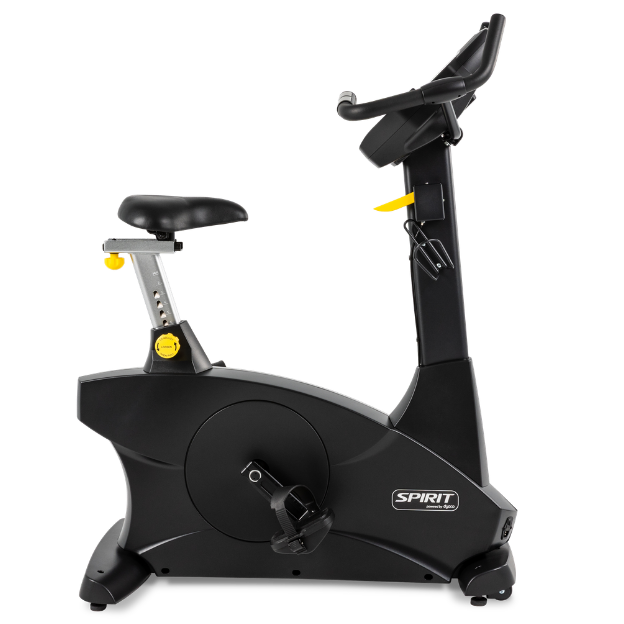 A black Spinfit indoor exercise bike with a silver and black seat, yellow adjustment knobs, and a black handlebar, shown against a plain white background.