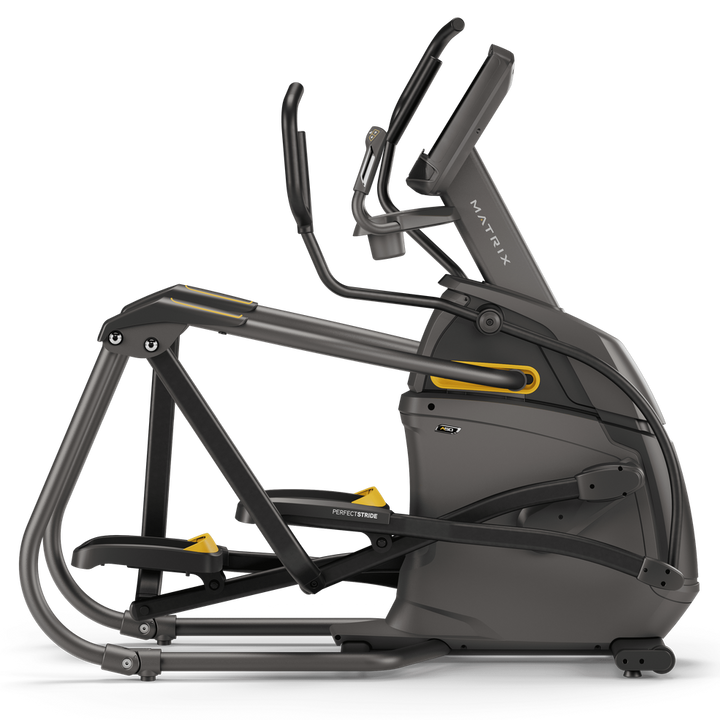 Matrix commercial-grade elliptical cross trainer in dark gray and black with yellow accents, shown from a side profile view on a white background.