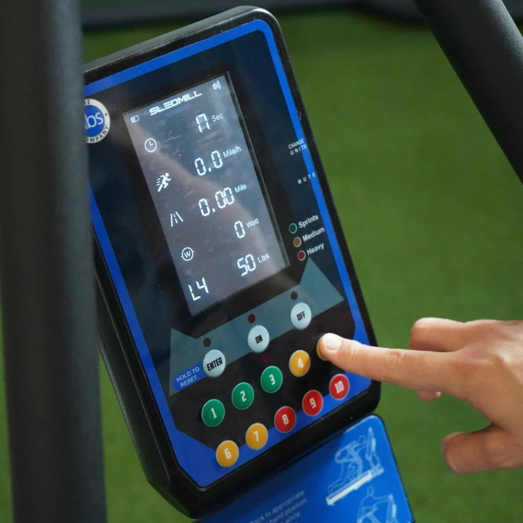 Person interacting with a digital display on a piece of exercise equipment